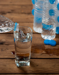 Water pour on to glass on wood