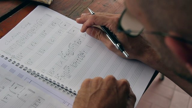Musician writing music composition