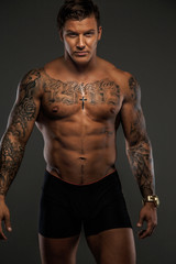 Fototapeta na wymiar Shirtless muscular tattooed man.