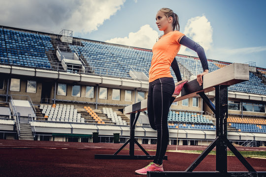 Blond woman in sportswear doing exercises.