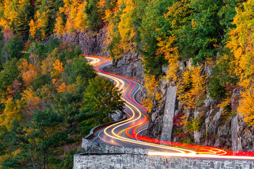 Traffic light trails on Hawk's Nest winding road (route 97) in Upstate New York, on an autumn...