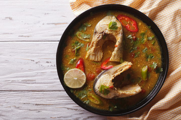 spicy fish curry with cilantro on the table. horizontal top view

