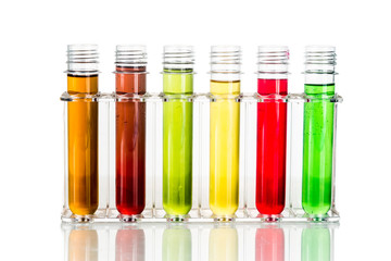 Test tubes with multi color chemicals isolated in white