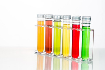 Test tubes with multi color chemicals isolated in white