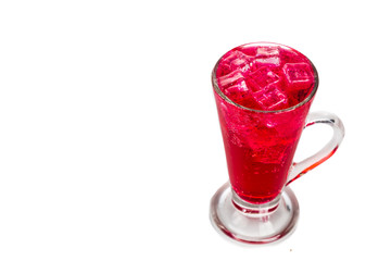 Refreshing red fizzy soft drink with ice in transparent glass