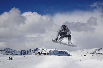 Flying snowboarder on mountains