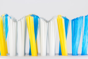 Macro photo of colorful toothbrush bristles isolated on a white background.