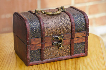 Old wooden chest on a wooden table.
