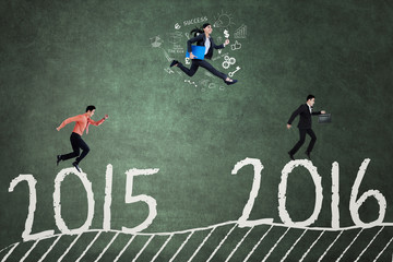 Business team jumps above numbers 2015 to 2016