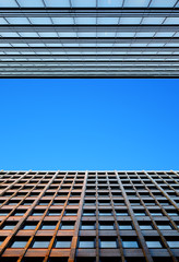 Fragment of modern buildings on the background of blue sky. Abst