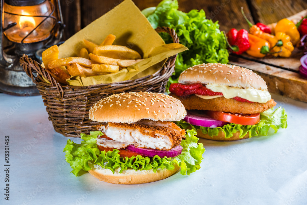 Wall mural juicy and tasty looking fish burger with fried potatoes