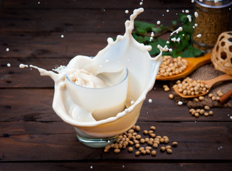 Soy milk splash with beans on wood