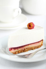 Fresh raspberry cheesecake on white plate