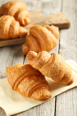 Tasty croissants on grey wooden background