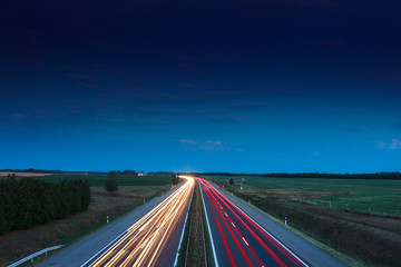 Cars speeding on a highway - obrazy, fototapety, plakaty