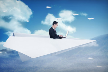 Asian business man working on paper plane
