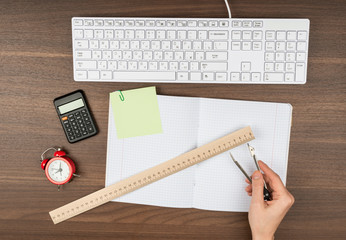 Humans hands with ruler and divider