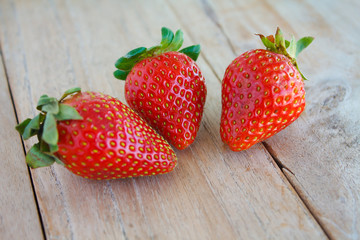 Fresh red strawberries on wooden table