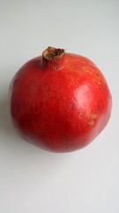One pomegranate on a light background