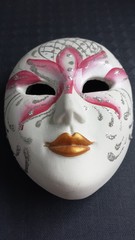 Venetian mask with plaster on dark background