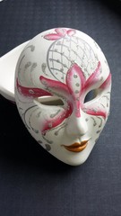 Venetian mask with plaster on dark background