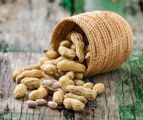  peanuts in the  basket on wood