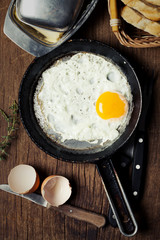 Breakfast setting with fried egg in skillet pan