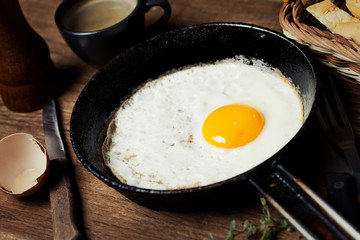 Breakfast setting with fried egg and coffee