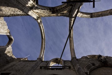 Fototapeta na wymiar Looking up at the roofless Carmo Convent in Lisbon, facing the sky
