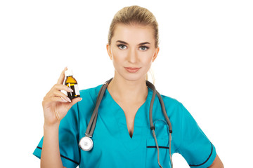 Female nurse or doctor holding medicine bottle in the hand