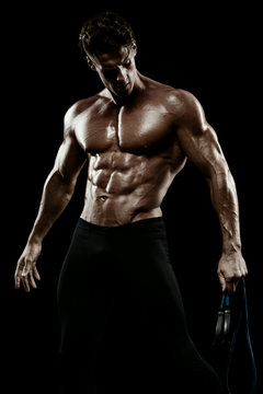 Muscular man bodybuilder. Man posing on a black background, show