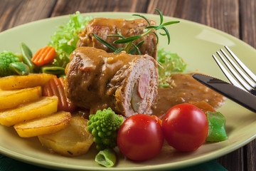 Pork rolls with prepared potatoes and vegetables