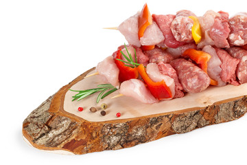 skewered meat and peppercorns on rustic cutting board