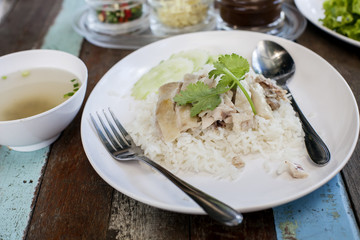 Thai food gourmet steamed chicken with rice ,in wood background.