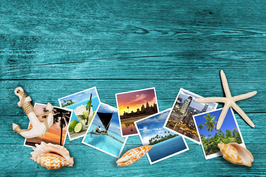 travel photos and seashells on azure wood background