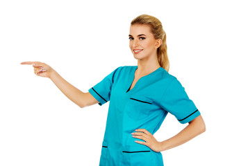 Smiling woman doctor or nurse pointing something