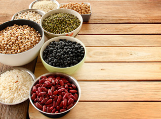 Different kinds of Grains, five grains put on wooden background.