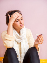 sick girl checks the temperature