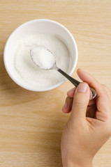 The spoon of sugar in the bowl,food ingredient for cooking sweet or dessert