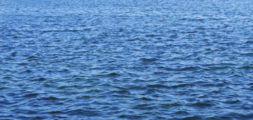 Close up on water surface. View of the dark blue sea.