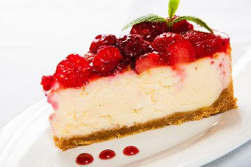 Cake with fresh culinary herbs strawberries on white plate