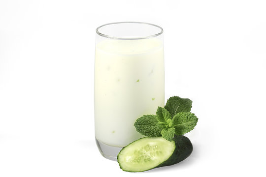 Cup of yogurt and cucumber on a white background