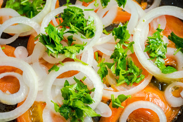 close up of chopped parsley onion and tomatoes frying