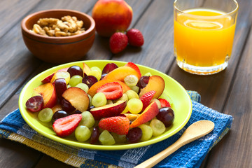 Fresh fruit salad made of grape, strawberry, plum and nectarine served on plate, photographed with...