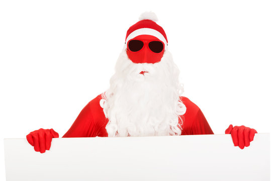 Portrait of santa man holding empty banner
