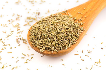 Dried rosemary leaves in wooden spoon