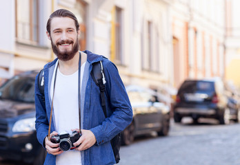 Cheerful bearded tourist is making his journey