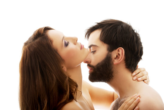 Man pretending to kiss woman's neck.
