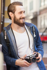 Cheerful young tourist is sightseeing with joy