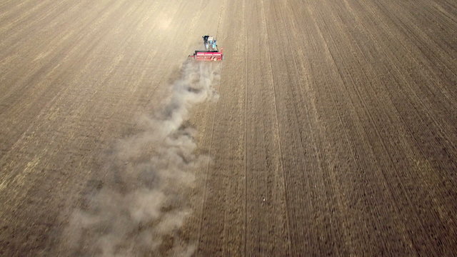 Aerial view of tractor sowing wheat
